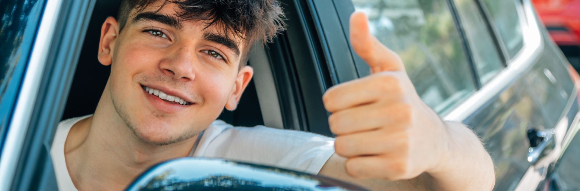 Teenage girl in blue hood reads in library, headphones and apple by her side.